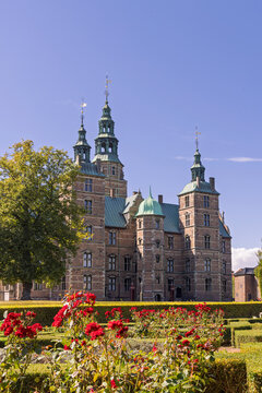 Rosenborg Castle in Copenhagen, Denmark, with green copper spires and surrounding garden and lush lawns