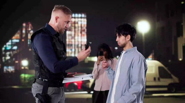 Police Officer Conducts Breathalyzer Test During Traffic Stop; Bystander