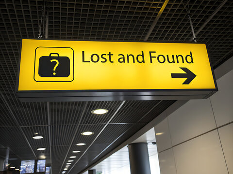 Illuminated Yellow Lost and Found Sign with Suitcase Icon and Arrow
