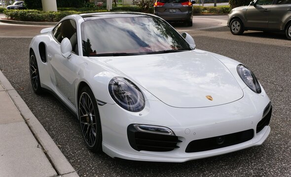 St Petersburg, Florida, U.S - Jan 3, 2026 - A pearl white Porsche 911 Turbo S parked street-side, showcasing sleek design, luxury styling, and performance engineering in urban setting