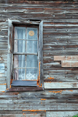 Rustic window reveals weathered texture and vintage facade