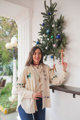 traditional Ukrainian embroidered costume decorates a house porch with handmade straw ornaments, including an angel and a horse, reflecting Ukrainian folk culture and heritage.