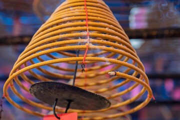 Man Mo Temple, Hong Kong, China : spiral incense coil burning inside the Taoist temple, symbol of prayer, time and devotion, with smoke rising in the ritual space