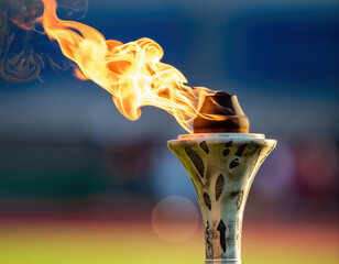 Torch with flame lights up the stadium before the competition at the sports event