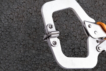 Tool for holding objects tightly in place during woodworking or metalworking tasks in a workshop environment