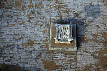 Aerial view of the intricate stone patterns surrounding a central structure, revealing the ancient craftsmanship of the site, Hampi, Karnataka, India.