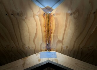 Plywood Roof Structure with Severe Water Damage and Rust Stains, Symbolizing Structural Deterioration, Home Maintenance, Building Repair, Insurance