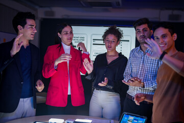 Successful creative team celebrating project achievement in modern office. Happy diverse developers...