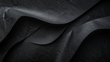 Overlapping black textured paper sheets—minimalist composition with crumpled layers and soft lighting creates abstract depth, tonal contrast, and visual intrigue in a monochromatic design.