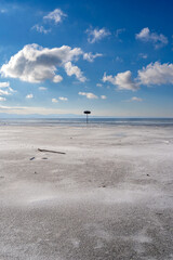 frozen bay of Lake Constance in Wasserburg Germany with blue sky and clouds