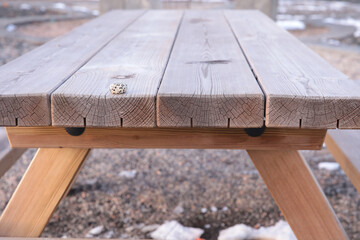 Fototapeta premium Wooden picnic table with dice on snowy ground