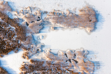 Frozen lake covered in snow, seen from a drone. Winter landscape. Lake Dabie in Poland.