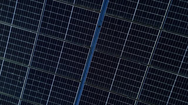 Top down aerial view of small solar panels, photovoltaic energy generation for industrial business park buildings,  sustainable energy in the United Kingdom