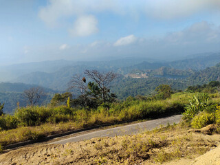 Beautiful Mountain Road Landscape with Green Hills and Clear Blue Sky