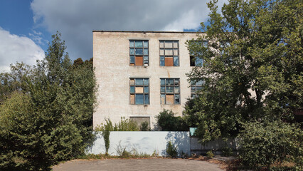 Abandoned industrial building with broken windows