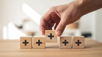 Adding Value & Positive Growth: Hand Stacking Wooden Blocks with Plus Signs