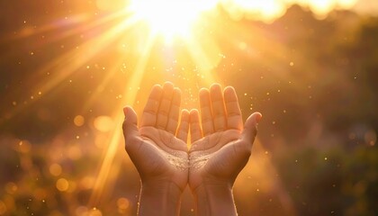 Open palms raised toward bright warm sun rays with sparkling particles and soft bokeh background for hope and gratitude