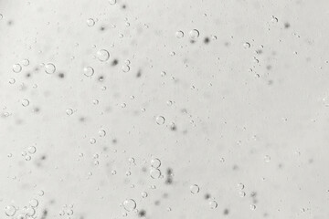 Light Gray textured gel background with bubbles close up. Concept of cosmetic, medical and other laboratory research. Selective focus. Demonstrating color of 2026 year, Cloud, Dancer
