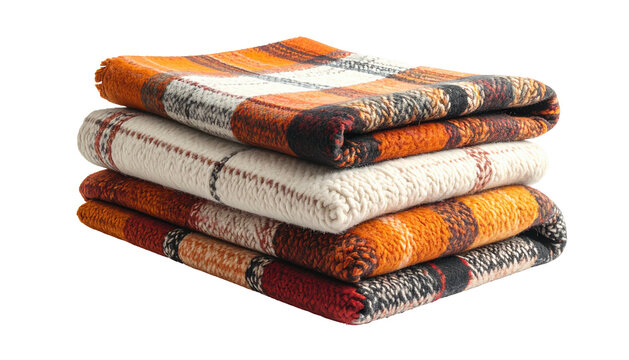 Stack of four folded, plaid blankets with autumn color schemes