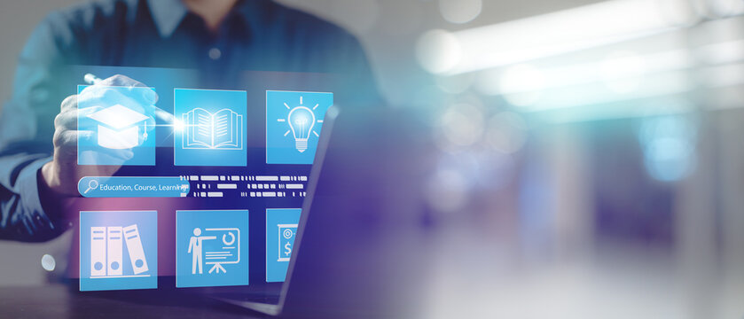Businessman using digital interface for online education, e-learning, and knowledge management system, representing modern technology for remote learning and virtual classroom solutions. - Powered by Adobe