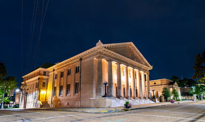 Galloway Memorial United Methodist Church in Jackson, Mississippi, USA. Historic Neoclassical architecture features the illuminated portico and massive stone columns under a dark night sky