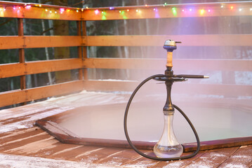 Elegant shisha arrangement amid vibrant lights and cozy ambiance