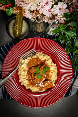 Chunky beef stew with savory sauce, served with bulgur groats.