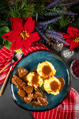 Beef goulash with mashed potatoes and grated beetroot.