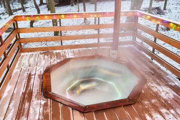 Scene of warm steaming bath in rustic setting with bubbling water and mist