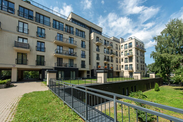 Modern Residential Building Surrounded by Greenery on a Sunny Day