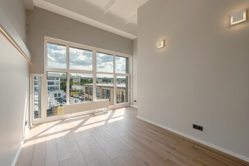 Bright Modern Loft Room Interior with Wooden Flooring and Large Window