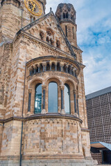 Fototapeta premium The Evangelical Lutheran church Kaiser-Wilhelm-Gedächtniskirche, colloquially known as Gedachtniskirche, is located on Breitscheidplatz. Berlin