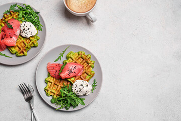 Healthy breakfast with green avocado based waffles and salmon