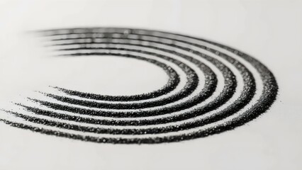 Concentric arcs of graphite powder forming abstract carbon whisper macro texture in close‑up detail design