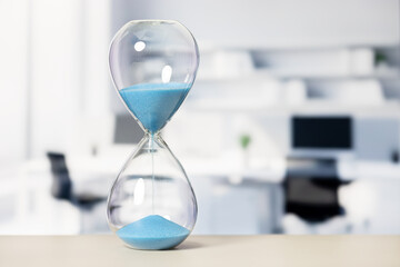 Hourglass measuring time in a modern office