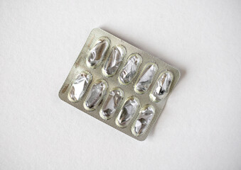 Empty metal blister pack for capsules isolated on white background. Used silver blister for capsules