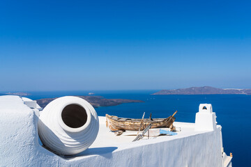 Old shipwreck boat on top of a white washed building in Fira, Santorini, Greece