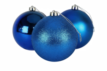 Three varied blue Christmas baubles displayed in a dark setting