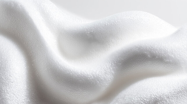 Smooth cosmetic mousse foam smear, airy and fluffy white texture with glossy highlights, soft and light appearance, isolated on clean white background, minimal skincare aesthetic