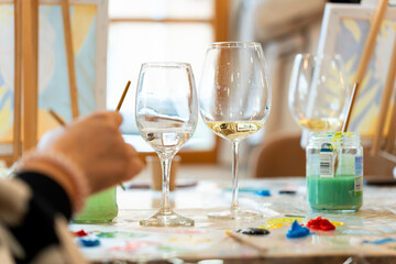 People enjoying creative sip and paint art class