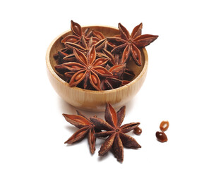 Star anise with seeds in bamboo bowl isolated on white background, side view  