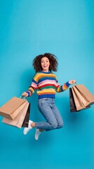 happy woman shopping bags smile jumping blue studio vertical background