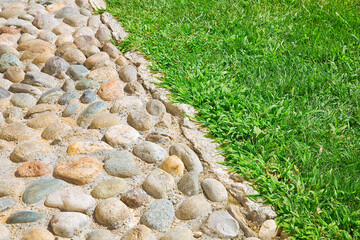 Rounded pebble floor with polished stone and grass area