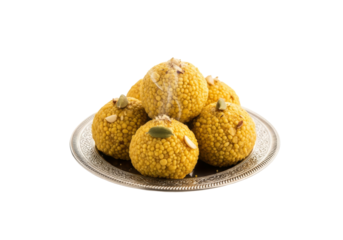 yellow bumpy fruits on decorative silver plate - food display