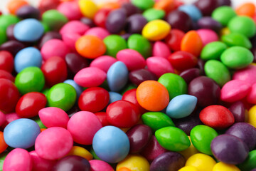 Many delicious colorful candies as background, closeup