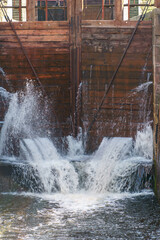 The old wooden gateway gate. The leaky lock gate on the canal. The leaking water is pressurized through holes and crevices.