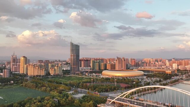 Sanmenxia City Skyline with Modern Stadium and Yellow River at Sunset