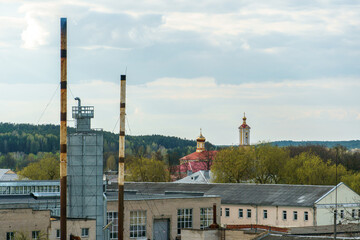 the territory of an old factory. Old brick boiler house buildings with high-protruding pipes.