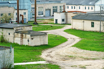 the territory of an old factory. Old brick boiler house buildings with high-protruding pipes.