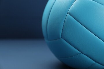 One volleyball ball on blue table, closeup. Space for text